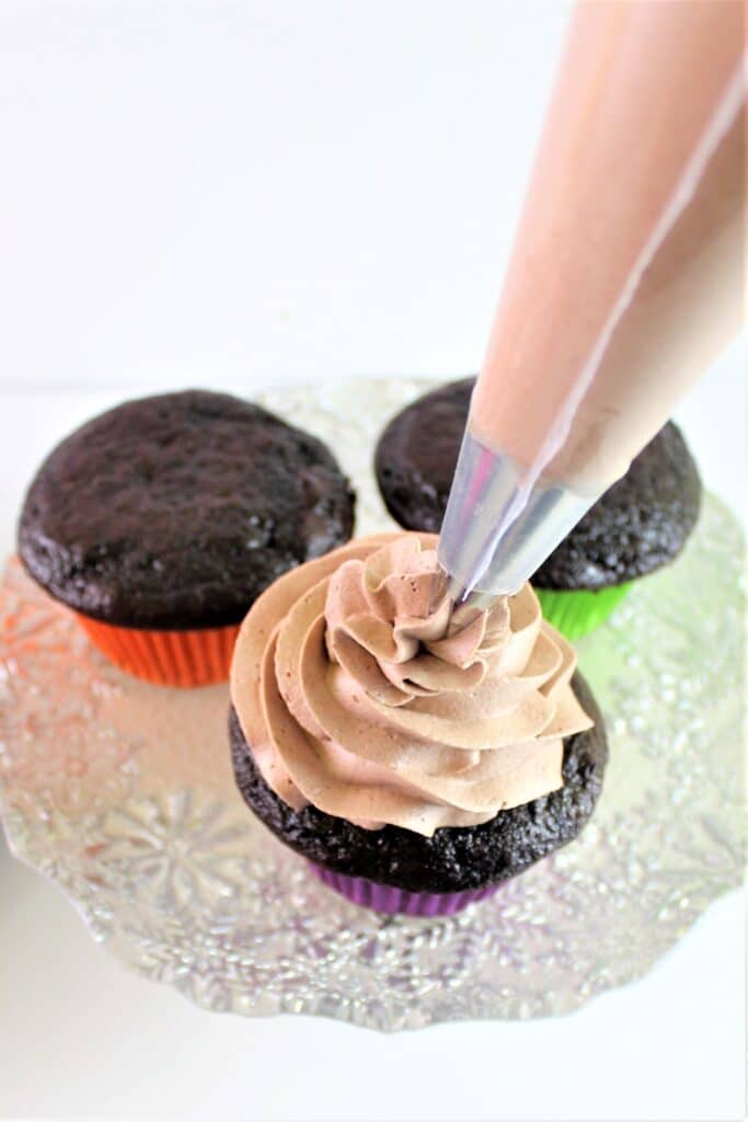 piping frosting on mexican chocolate cupcakes