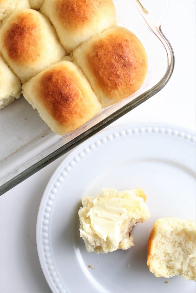 overhead shot of gf hawaiian rolls in pan and one on plate