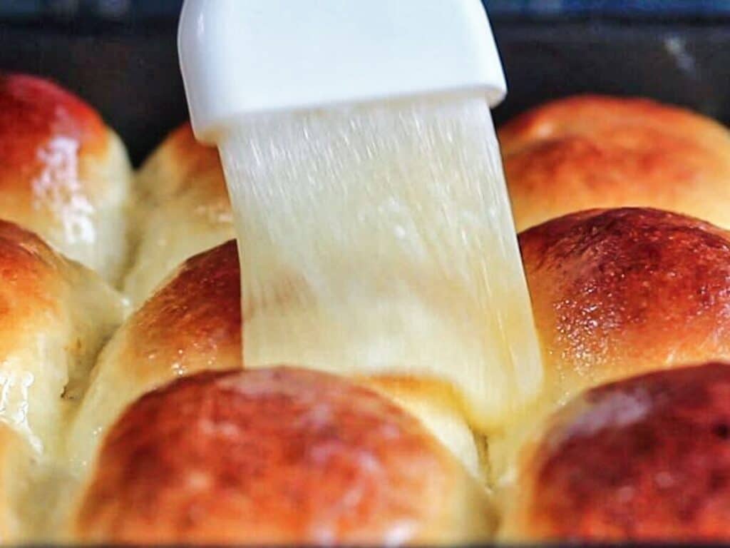 brushing baked rolls with melted butter.