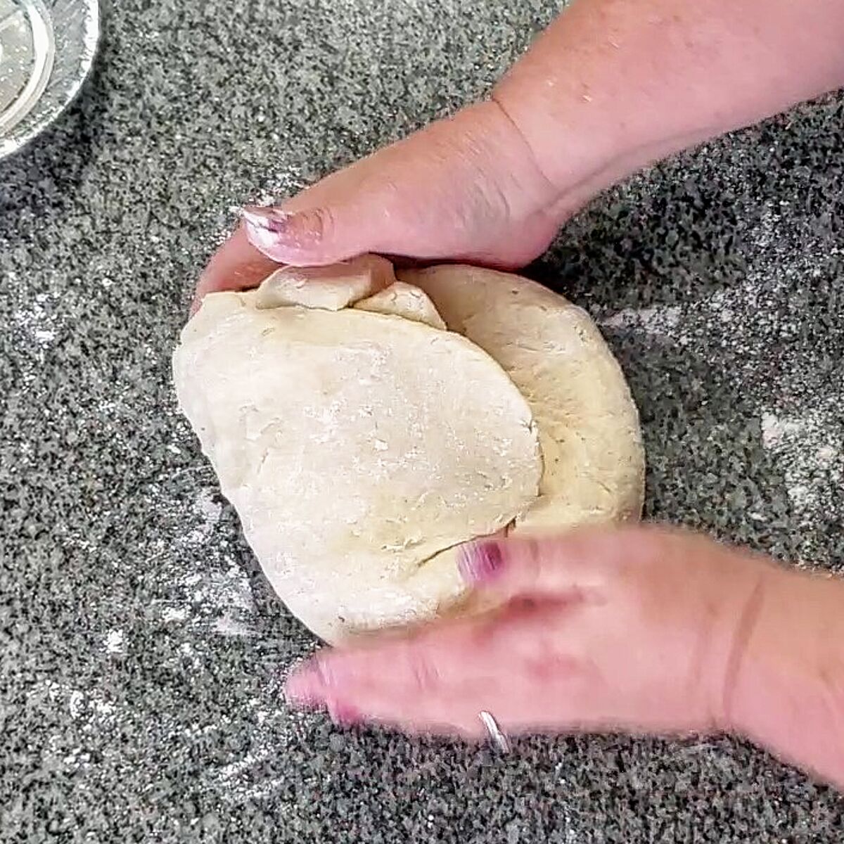 kneading dough on granite countertop.