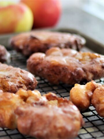 landscape view of gluten free apple fritters on wire rack