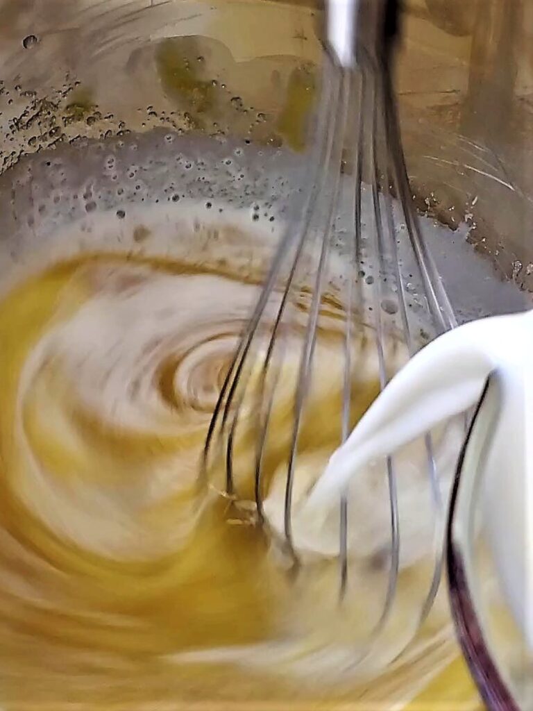 pouring milk into egg mixture