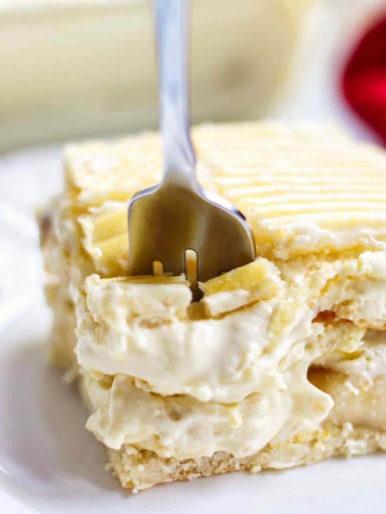 fork cutting into slice of banana pudding.