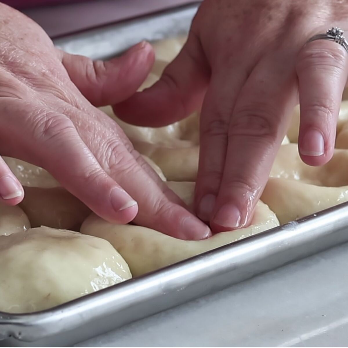 pressing into the center of each roll to make a well.
