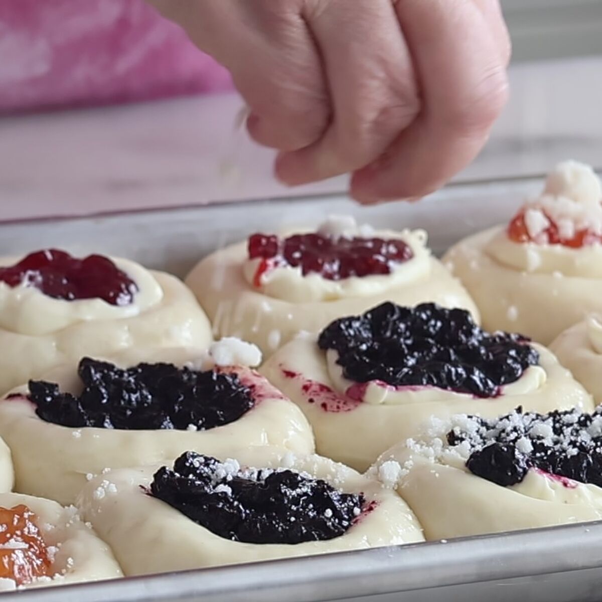 sprinkling streusel on top of each filled roll.