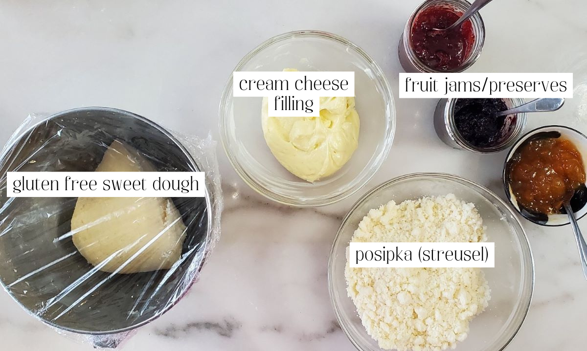 ingredients for kolaches measured out and labeled on white marble.