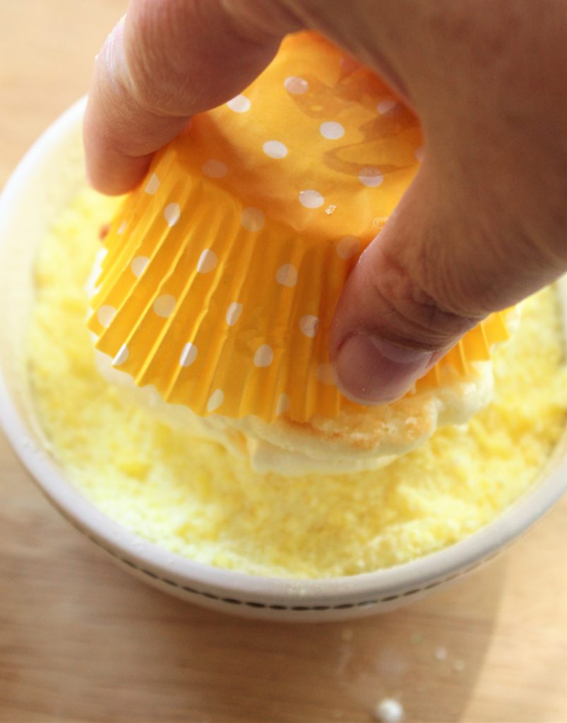 rolling cupcake in crushed lemon drops