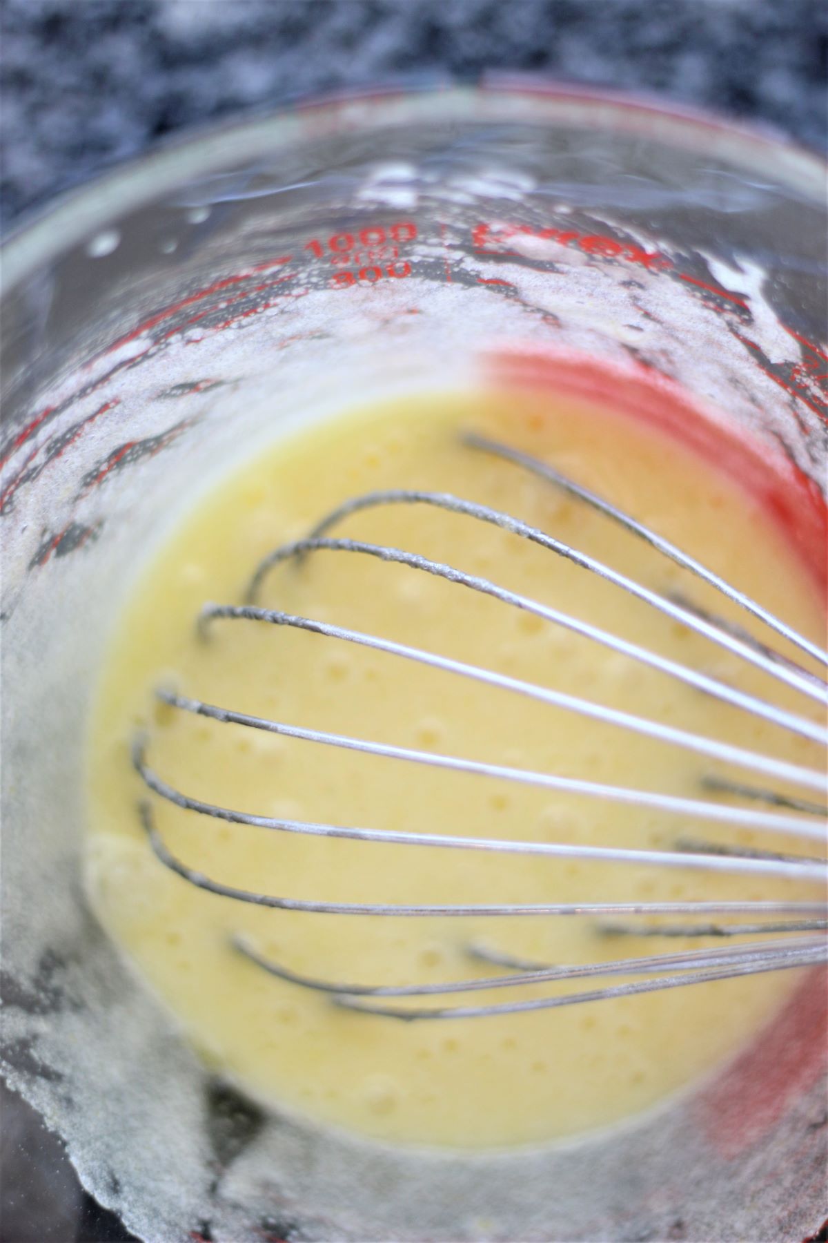 whisking wet ingredients in large pyrex measuring cup