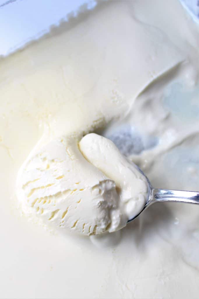 scooping clotted cream with spoon