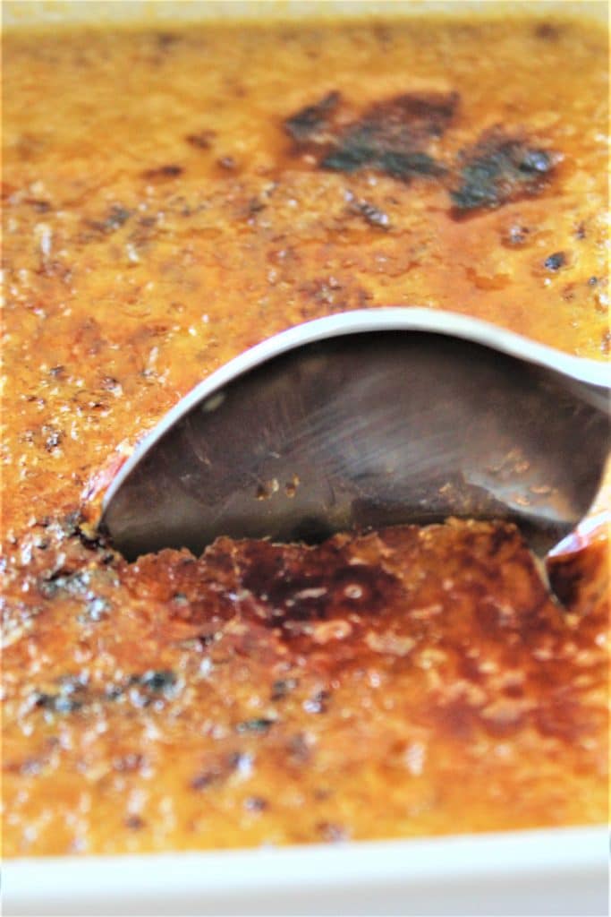 cracking through the creme brulee with a spoon