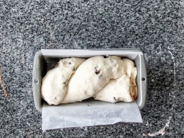 Dough placed in parchment-lined loaf pan.