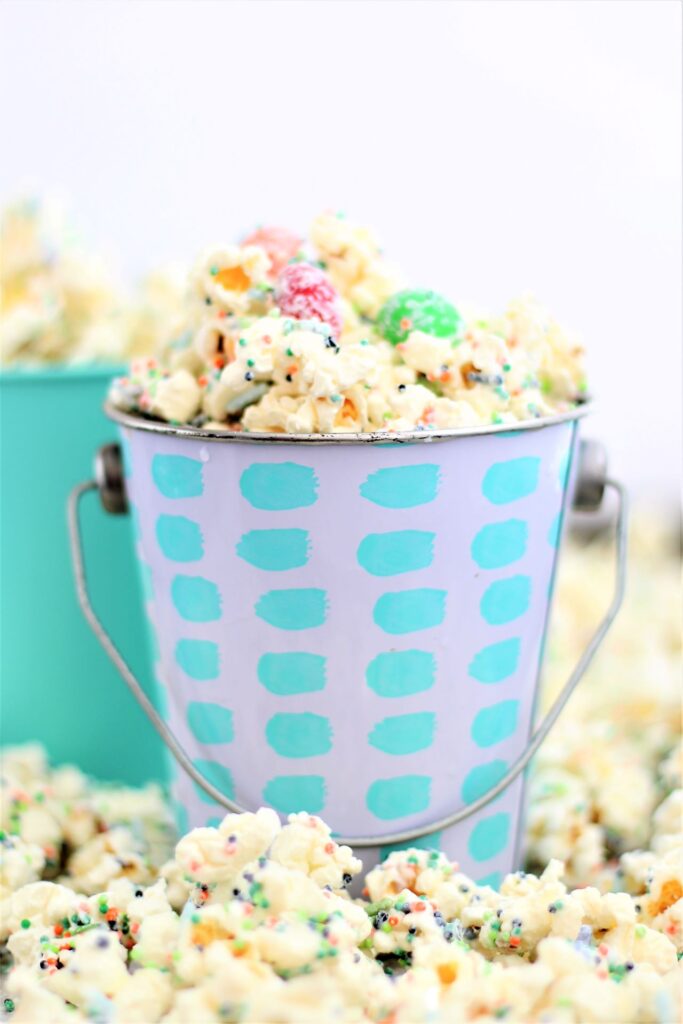 white chocolate popcorn in sea foam green small pail