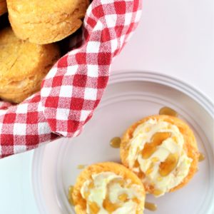 gluten free sweet potato biscuit split open and spread with butter and honey