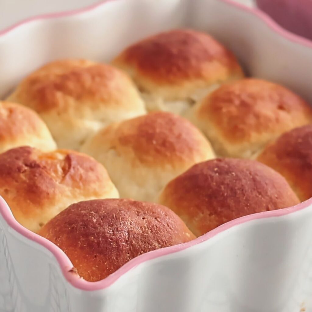 gluten free hawaiian rolls in white scalloped baking dish.