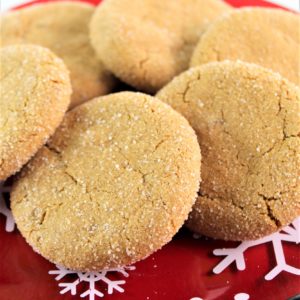 ultimate gluten free ginger cookies on a red snowflake plate