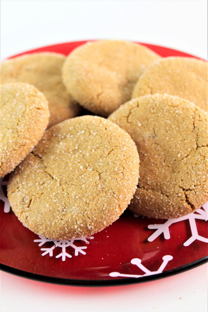 ultimate gluten free ginger cookies on a red snowflake plate