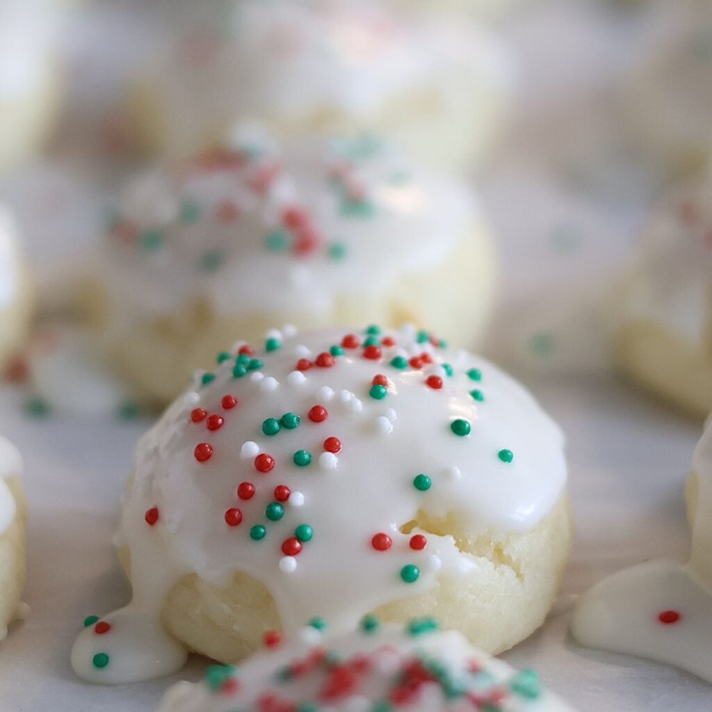 close up of ricotta cookies on parchment paper.