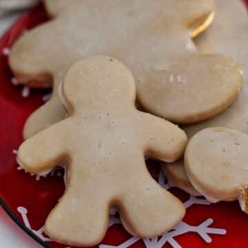 close up of mini gingerbread cookie on red holiday plate.