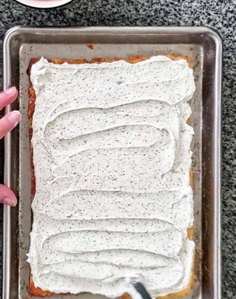 spreading cream cheese mixture onto flaky pastry.