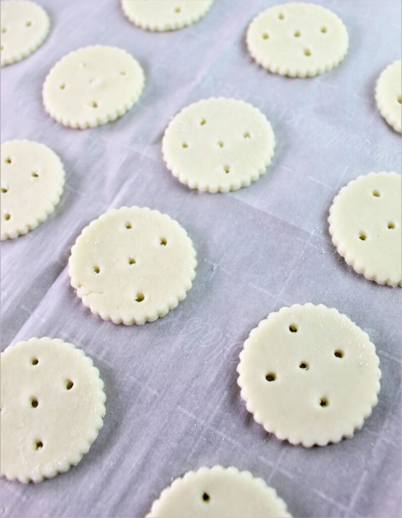 ritz crackers with holes getting ready to be baked