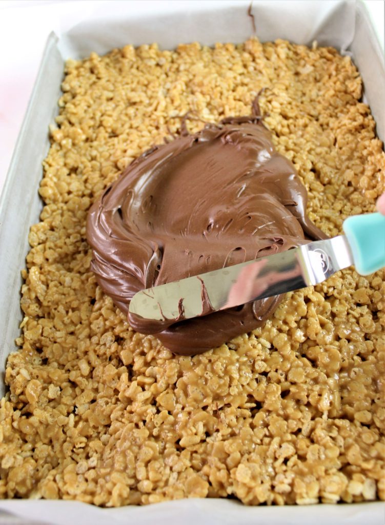 frosting scotcheroos with chocolate and butterscotch