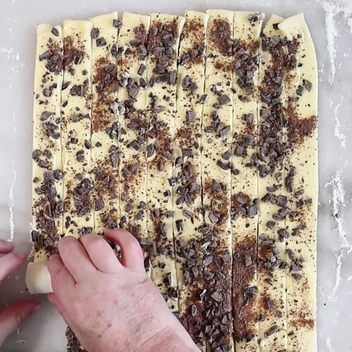 rolling up strip of dough to make a spiral.