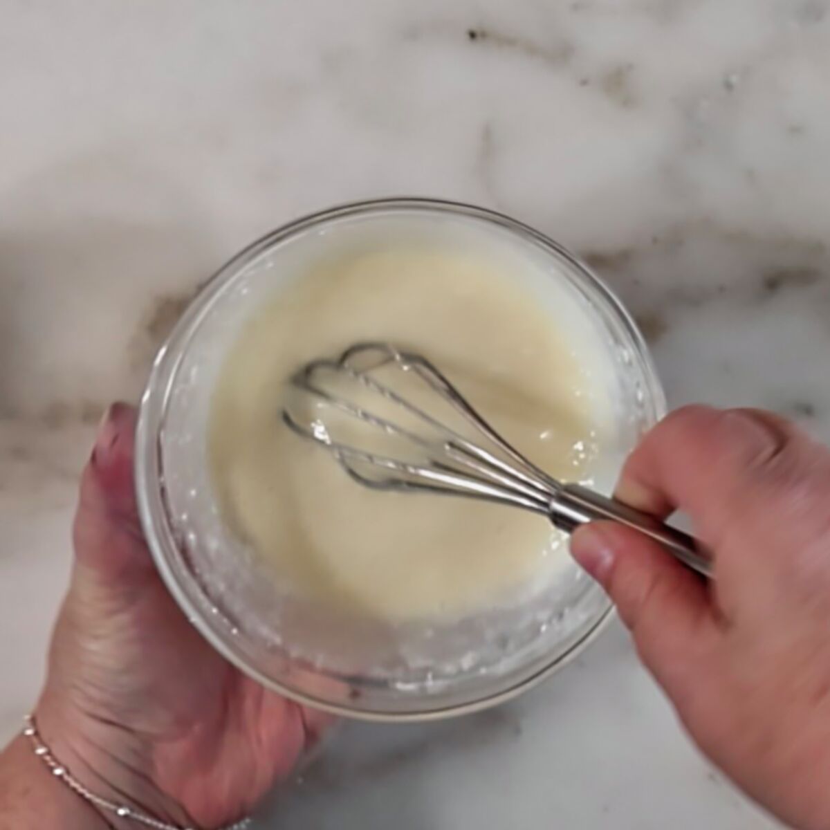 whisking glaze in small glass bowl.