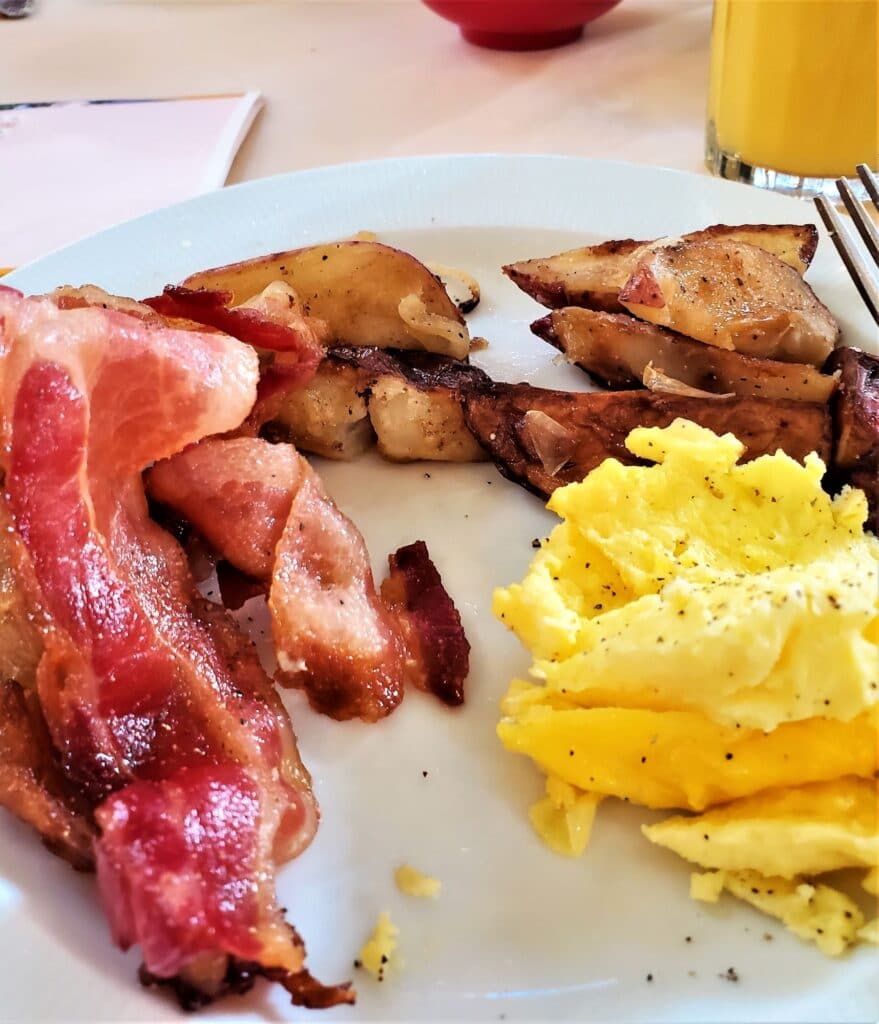 sausage, bacon, eggs, hash browns on a plate