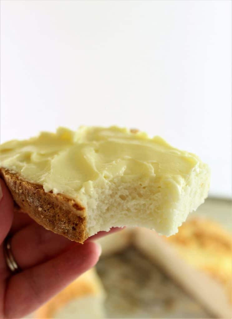 slice of bread with softened butter and a bite taken out