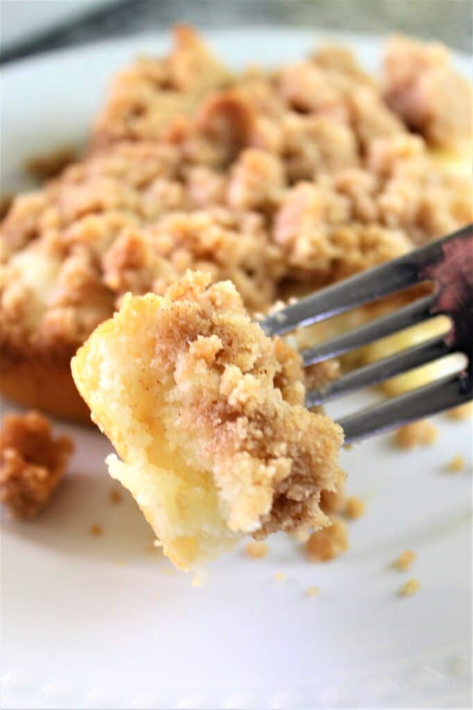 picking up a piece of crumb cake on fork