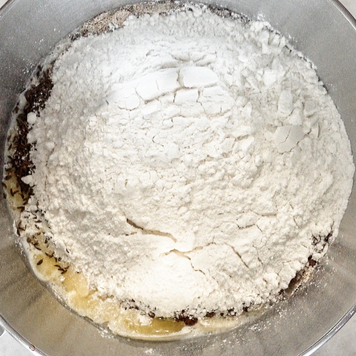 all ingredients for rye bread in stand mixer bowl.