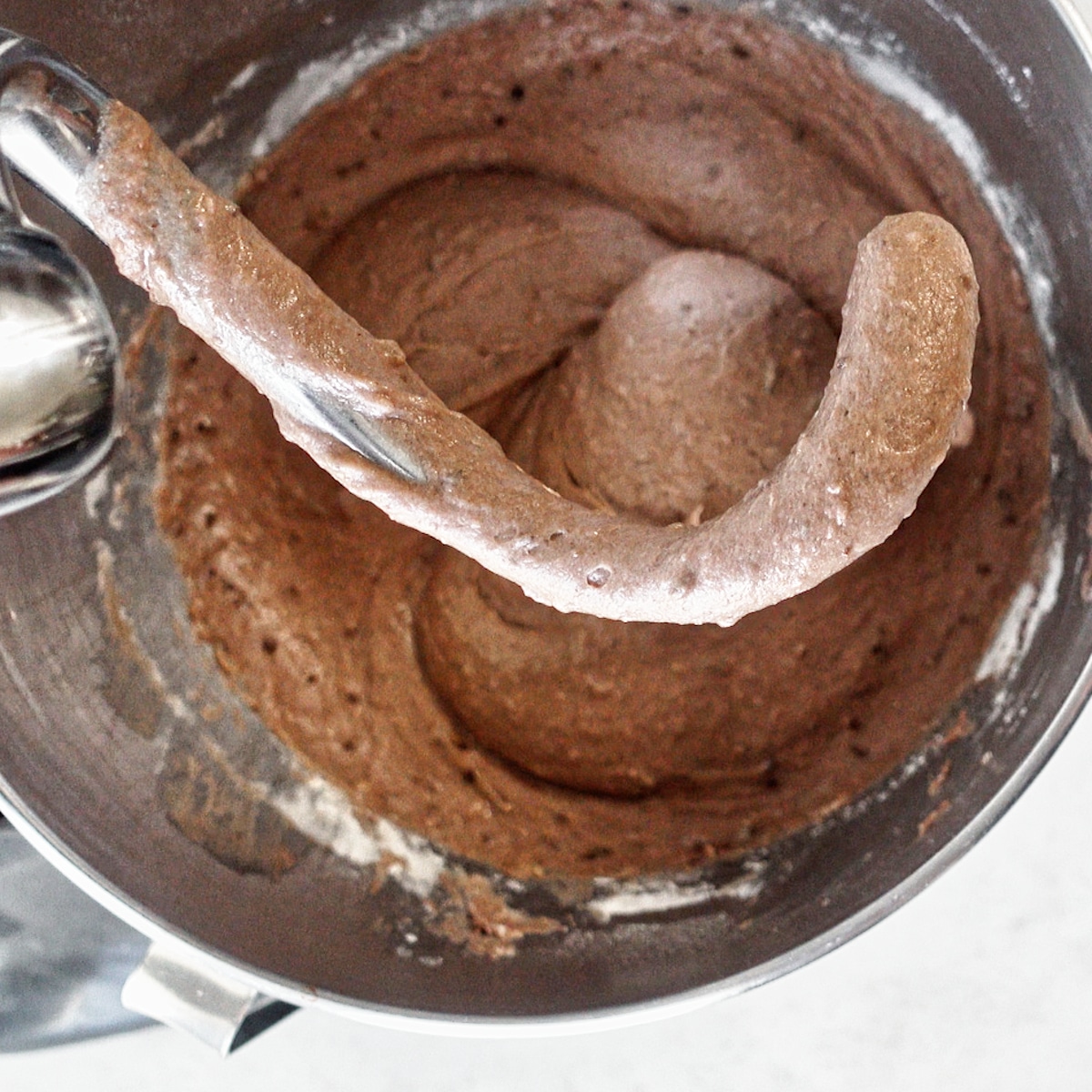 mixing dough in bowl of stand mixer with dough hook.