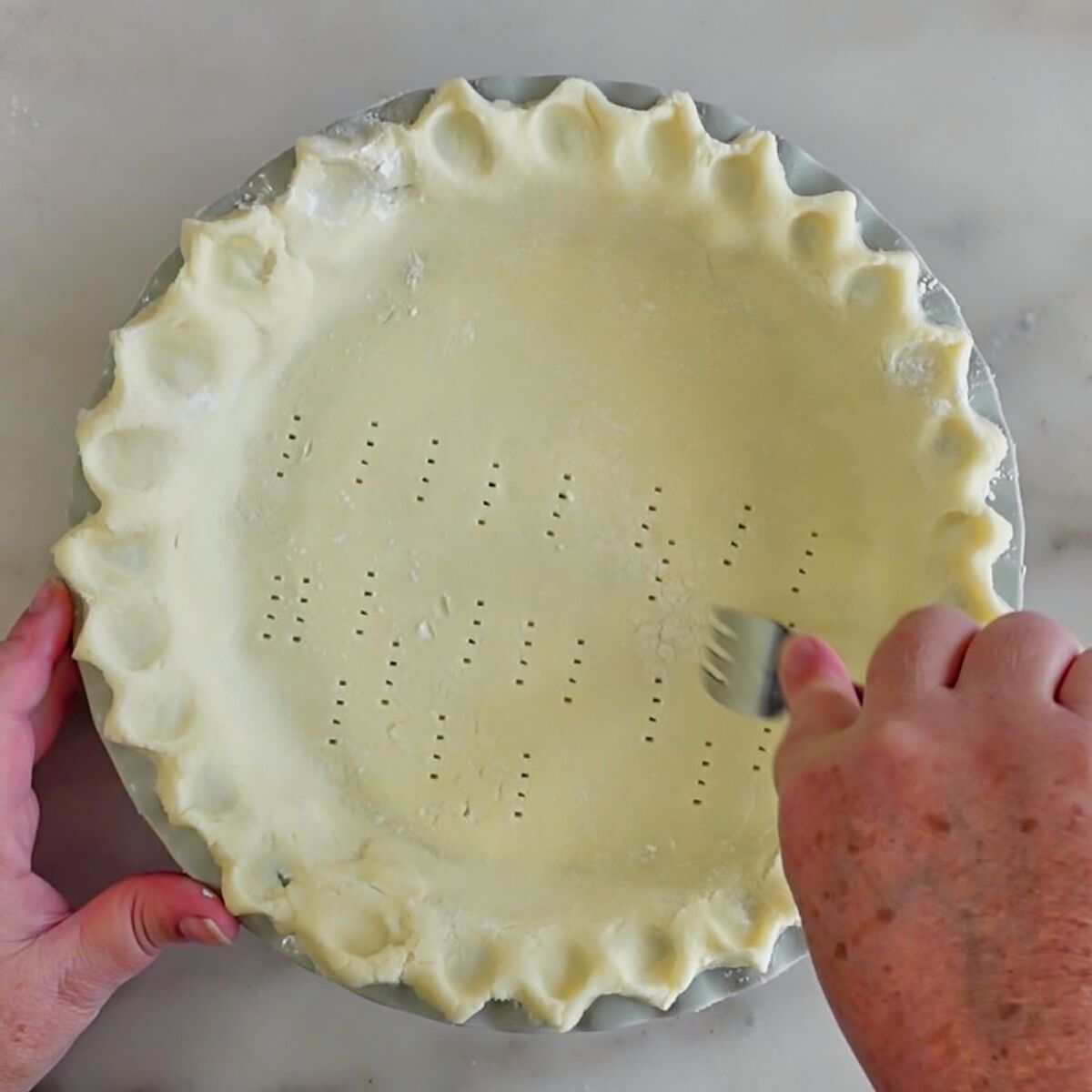 pricking bottom of pie crust with fork
