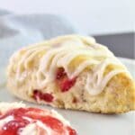 scone on plate with clotted cream swirled with jam