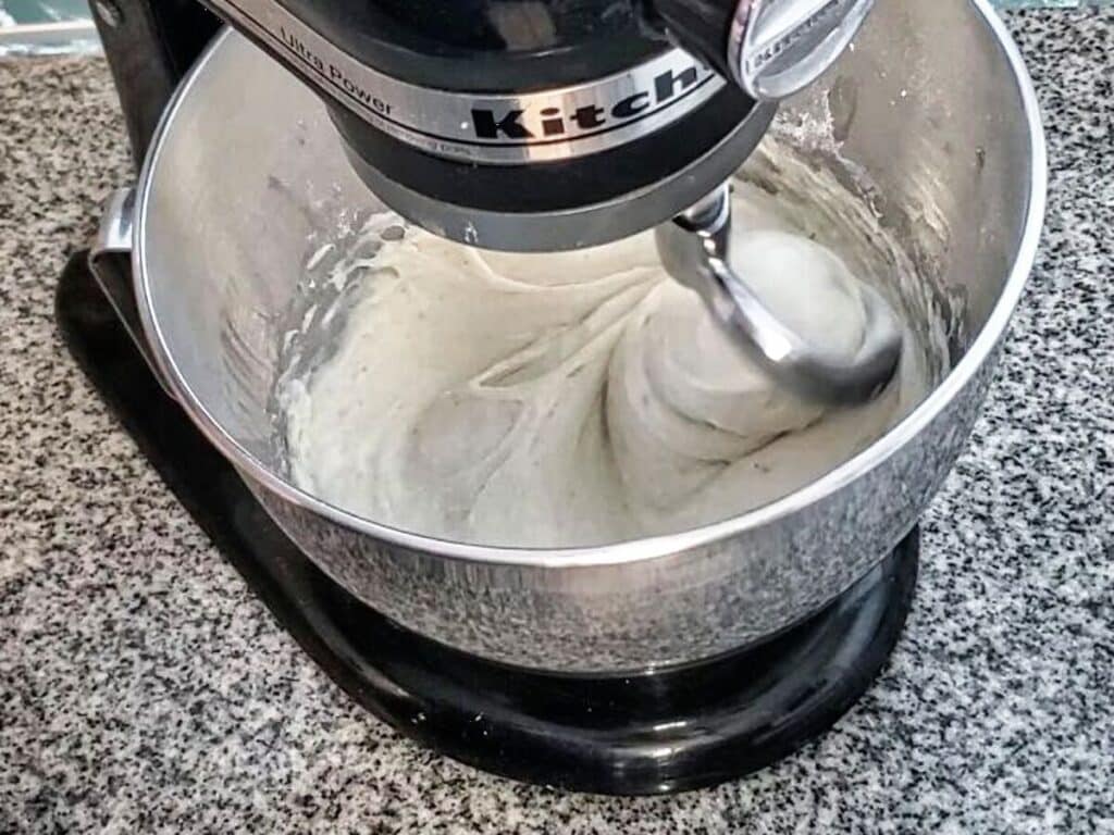 mixing dough on black kitchenaid stand mixer.