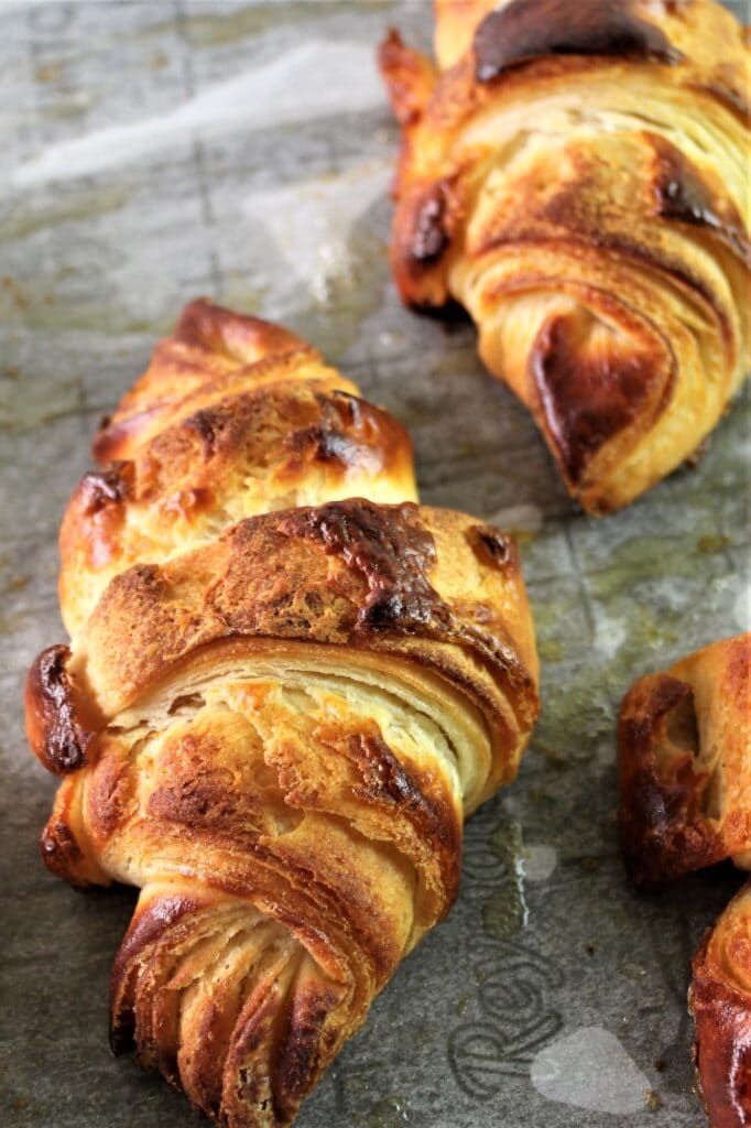 fully baked gluten free croissants on sheet pan