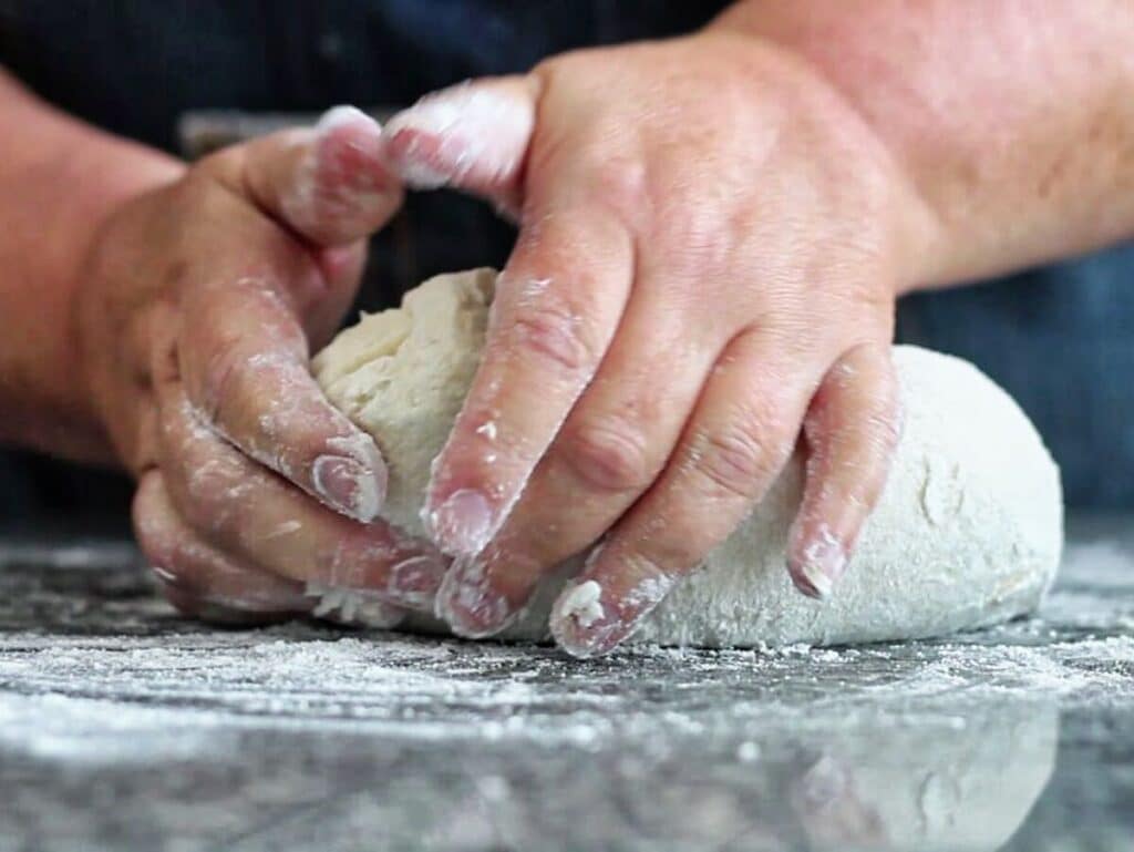 kneading dough on well-floured granite countertop.