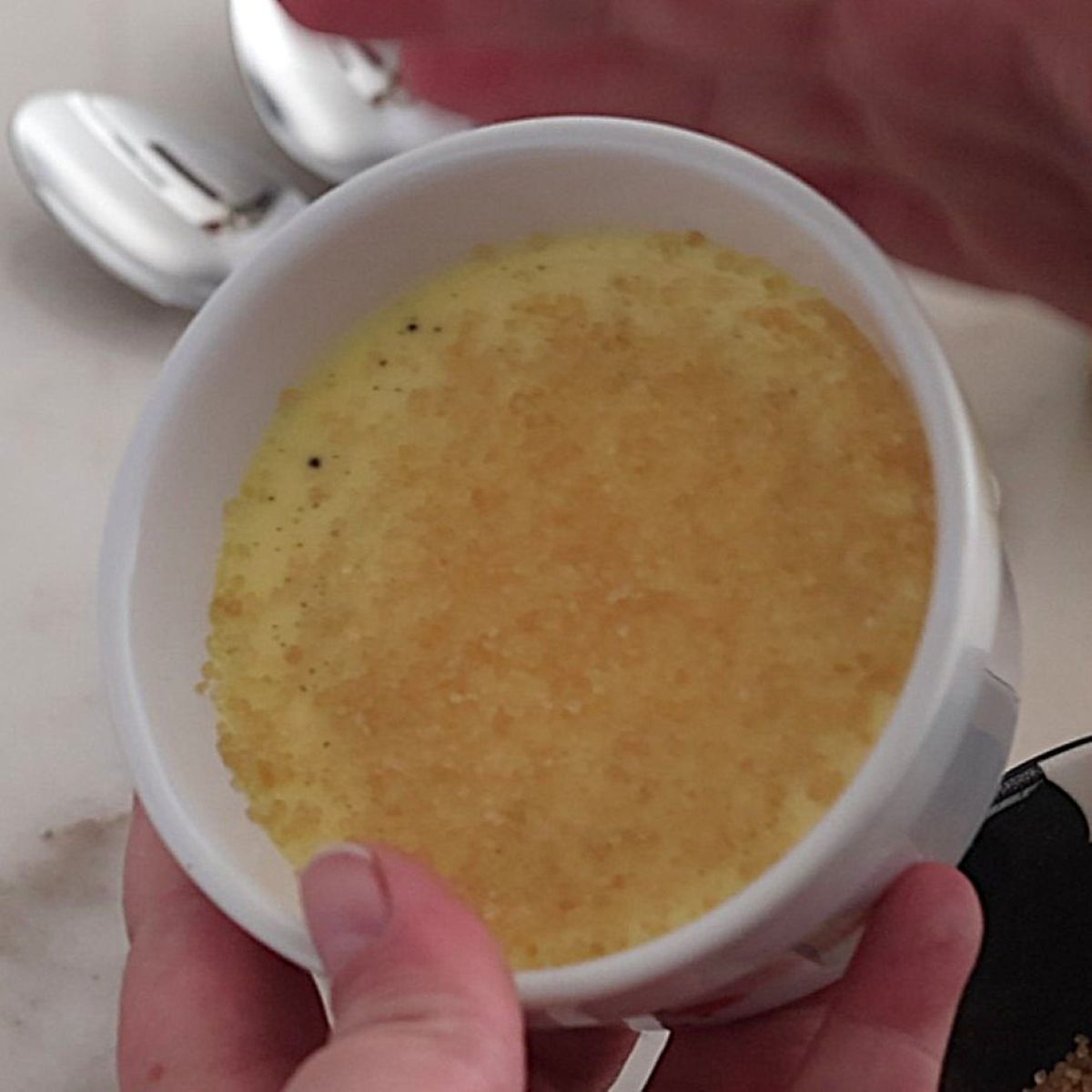 swirling sugar around on top of creme brulee.