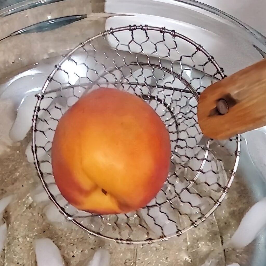 plunging boiled peach in ice water.
