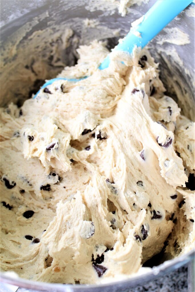cookie dough in bowl with blue spatula