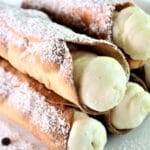 gluten free cannoli stacked on white cake stand