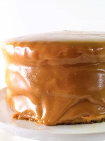gluten free caramel cake on white cake stand