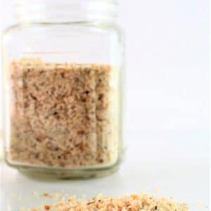 gluten free breadcrumbs in a glass jar and spilled out on a counter