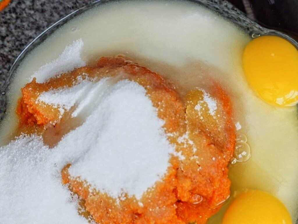 pumpkin, sugar, and eggs in large glass bowl.