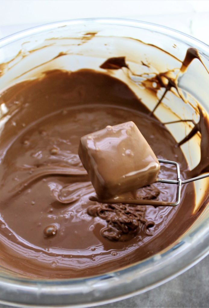 dipped ganache square fresh out of bowl of chocolate