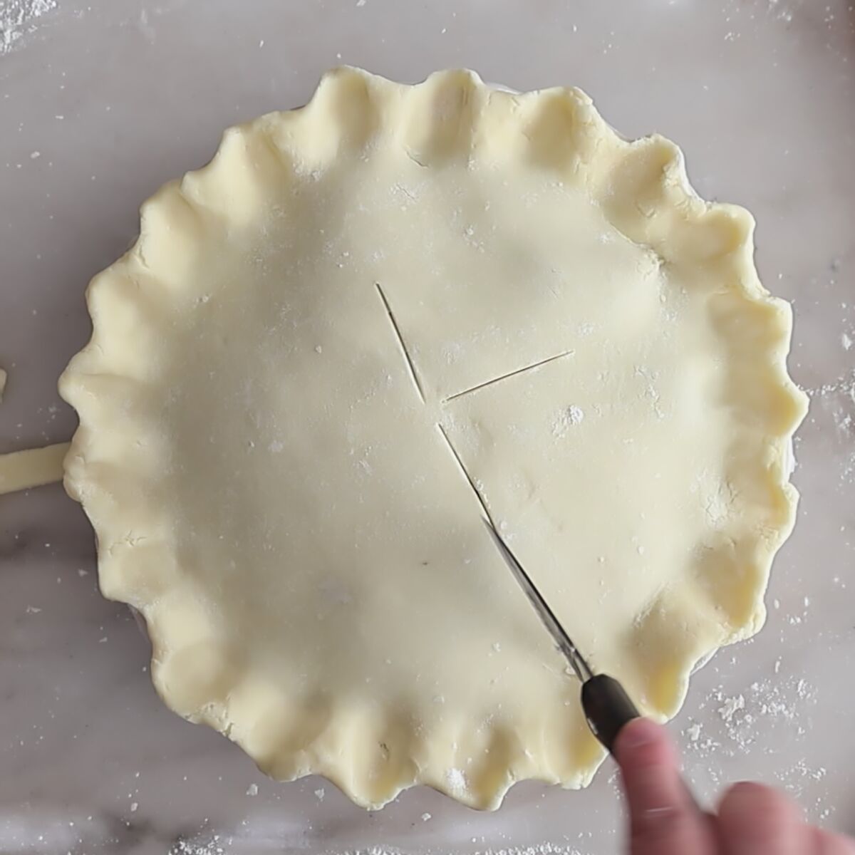 cutting slits in top crust.