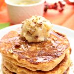 gluten free sweet potato pancakes on white plate with pecan honey butter
