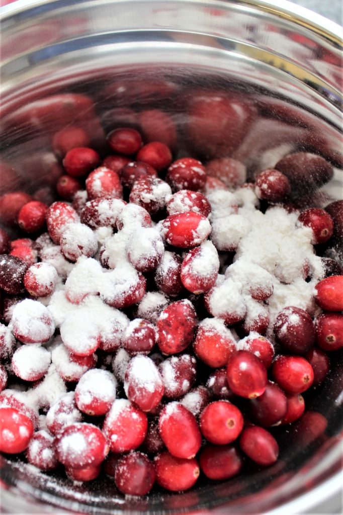 tossing cranberries with flour