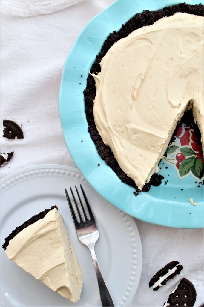 slice of pie on white plate with whole pie in blue pie pan