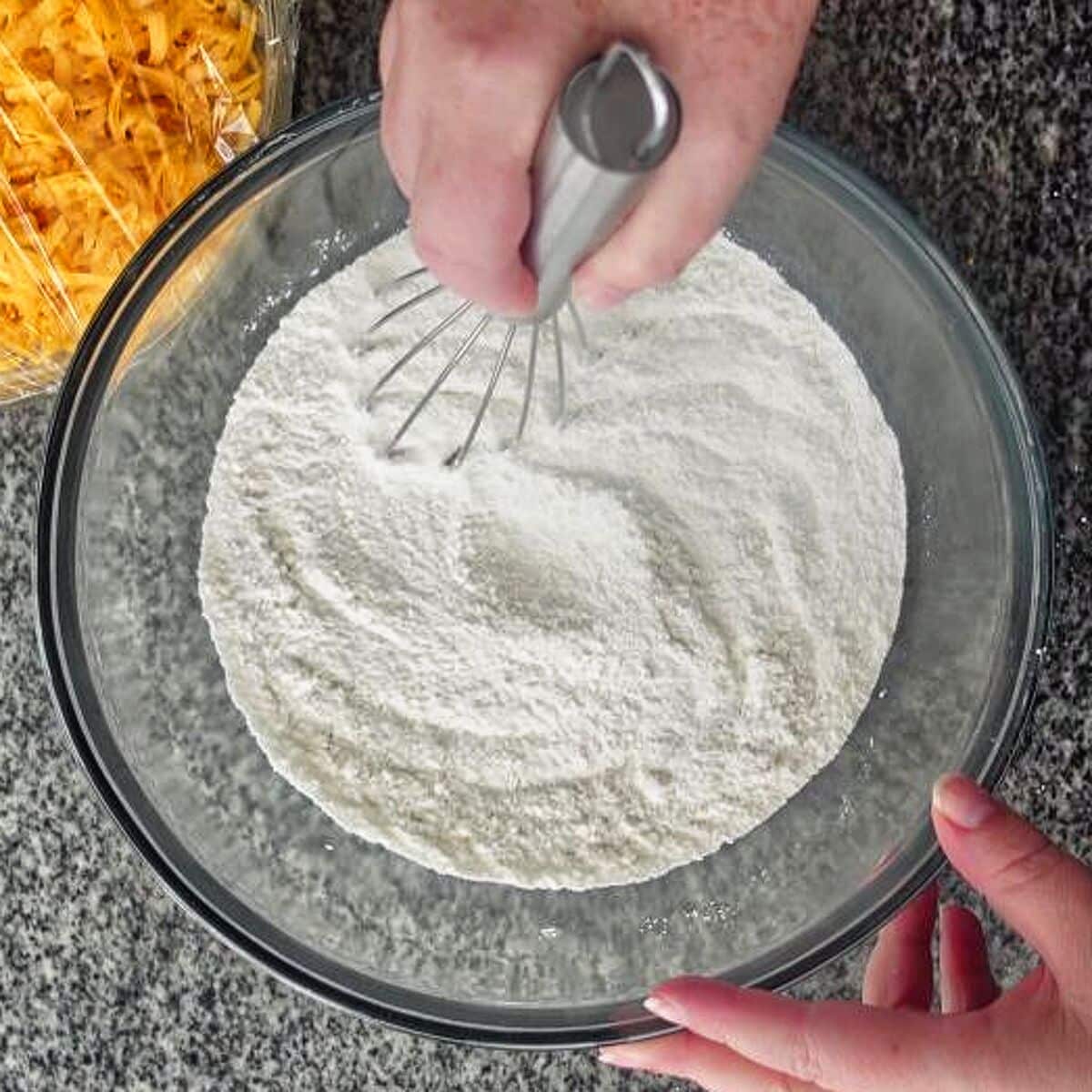 whisking together dry ingredients in large glass bowl.